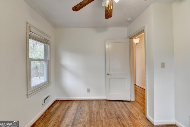 unfurnished room featuring visible vents, ceiling fan, light wood-style flooring, and baseboards