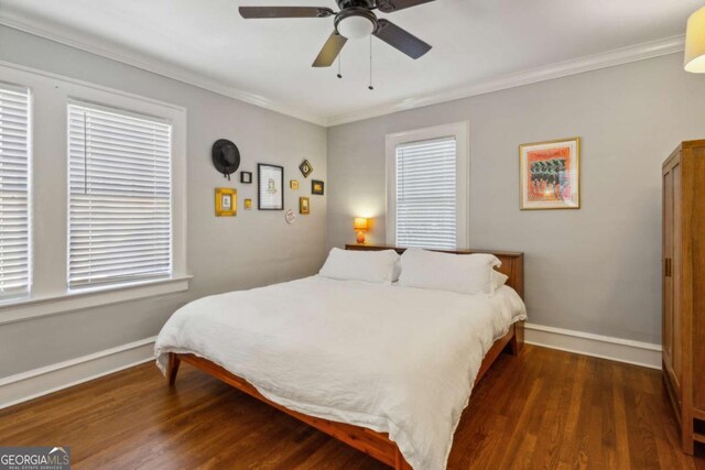 bedroom featuring crown molding, baseboards, ceiling fan, and dark wood-style flooring