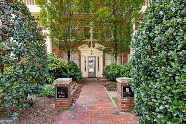 entrance to property featuring brick siding