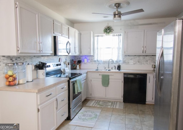 kitchen featuring white cabinetry, stainless steel appliances, a sink, and light countertops