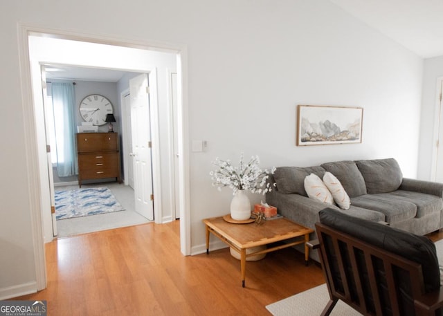 living area with light wood-style flooring and baseboards