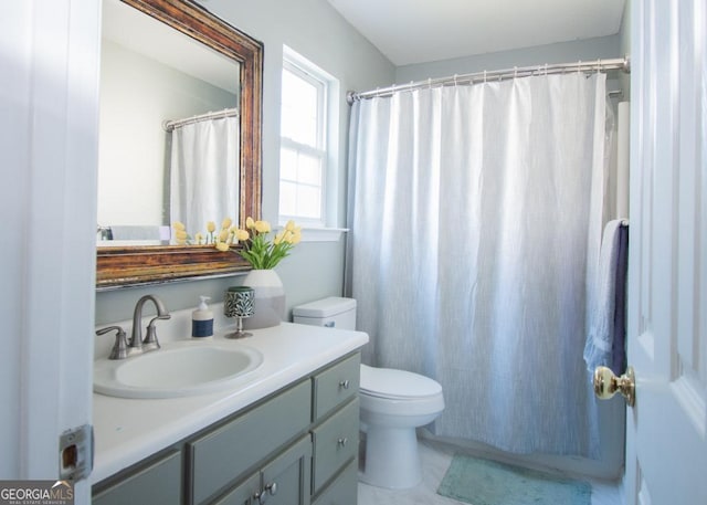 bathroom featuring toilet and vanity