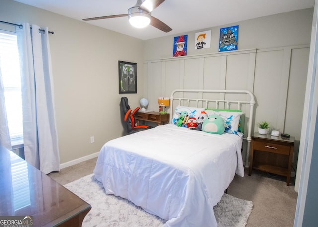 bedroom with ceiling fan, multiple windows, carpet, and baseboards