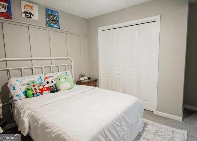 bedroom featuring baseboards, a closet, and carpet flooring