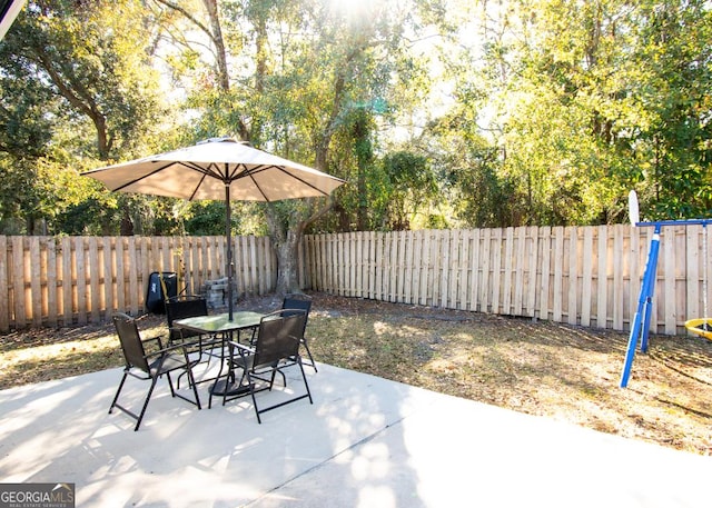 view of patio featuring outdoor dining space and a fenced backyard