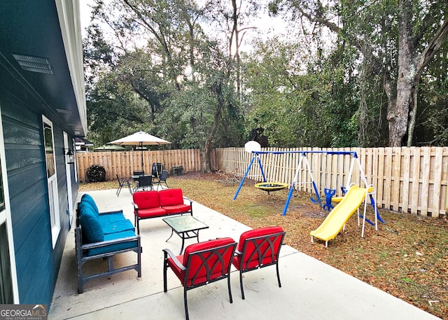 view of patio / terrace with outdoor dining space, an outdoor living space, a playground, and a fenced backyard