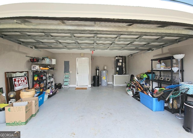 garage featuring electric water heater and heating unit