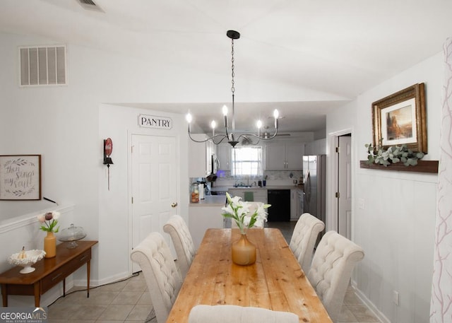 dining area featuring light tile patterned floors, baseboards, visible vents, vaulted ceiling, and a notable chandelier