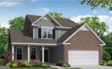 view of front of home with a front yard, driveway, and an attached garage