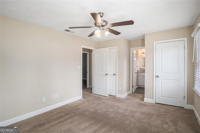 3822 Holland Dr, Snellville, GA 30039 - unfurnished bedroom featuring ceiling fan, light carpet, visible vents, baseboards, and ensuite bath