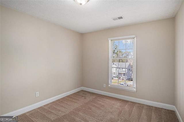3822 Holland Dr, Snellville, GA 30039 - spare room featuring a textured ceiling, carpet floors, visible vents, and baseboards