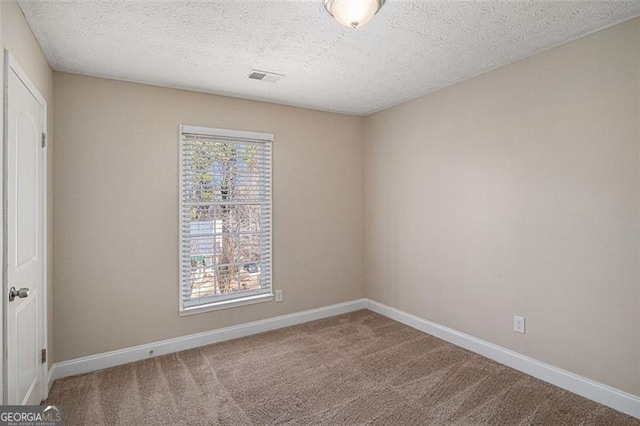 3822 Holland Dr, Snellville, GA 30039 - carpeted spare room with a textured ceiling, visible vents, and baseboards
