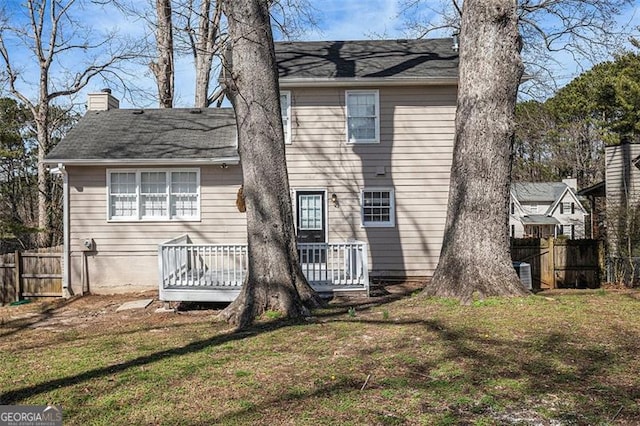 3822 Holland Dr, Snellville, GA 30039 - back of property featuring a lawn, a chimney, and fence