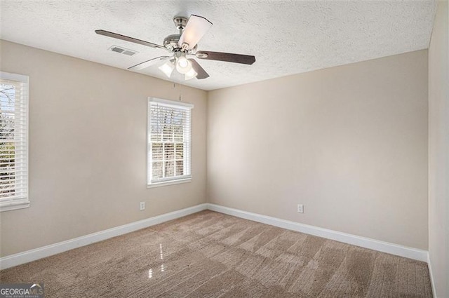 3822 Holland Dr, Snellville, GA 30039 - unfurnished room featuring a textured ceiling, carpet floors, visible vents, and baseboards