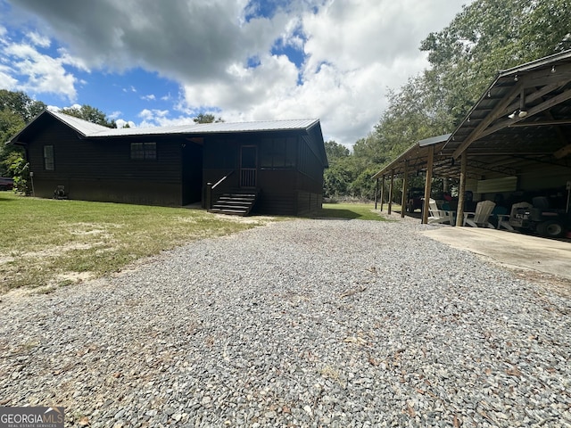 view of front of house with metal roof and a front yard