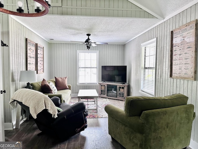 living room with crown molding, ceiling fan, vaulted ceiling, a textured ceiling, and wood finished floors