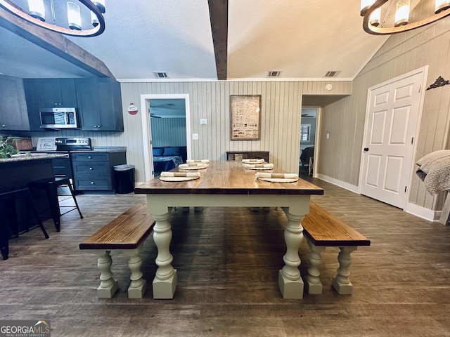 dining area featuring dark wood finished floors, visible vents, vaulted ceiling, and baseboards