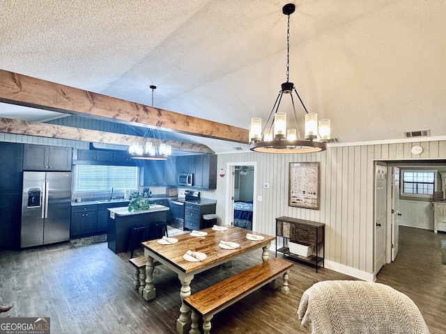 dining space featuring dark wood-style flooring, visible vents, a notable chandelier, and lofted ceiling with beams