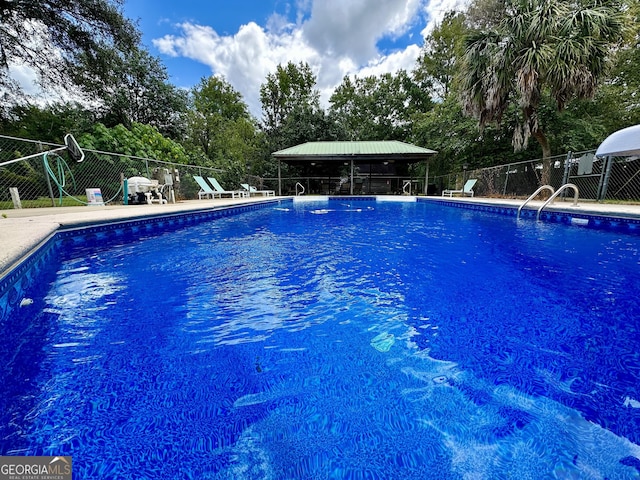 view of pool featuring fence and a gazebo