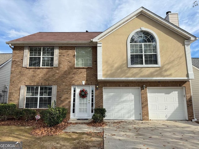 view of front of home featuring a garage, brick siding, concrete driveway, a chimney, and stucco siding