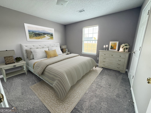 carpeted bedroom featuring visible vents, a textured ceiling, and baseboards