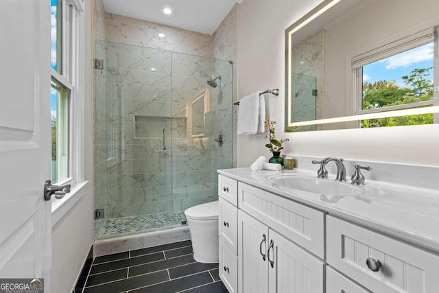 bathroom with toilet, recessed lighting, a marble finish shower, and vanity