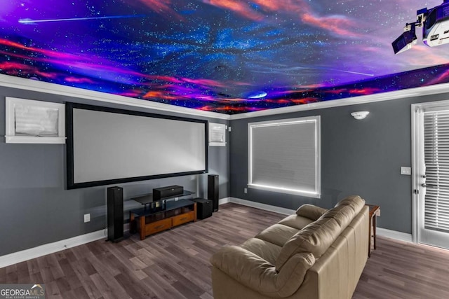 home theater room with baseboards and wood finished floors