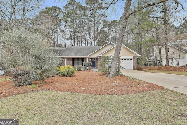 ranch-style house featuring a garage, driveway, brick siding, and a front yard