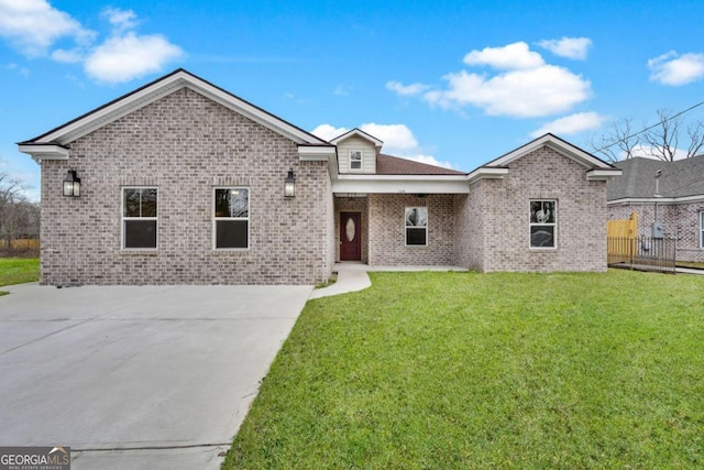 ranch-style house with brick siding, fence, and a front lawn