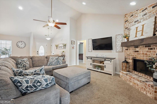 carpeted living area with baseboards, a ceiling fan, a brick fireplace, high vaulted ceiling, and recessed lighting