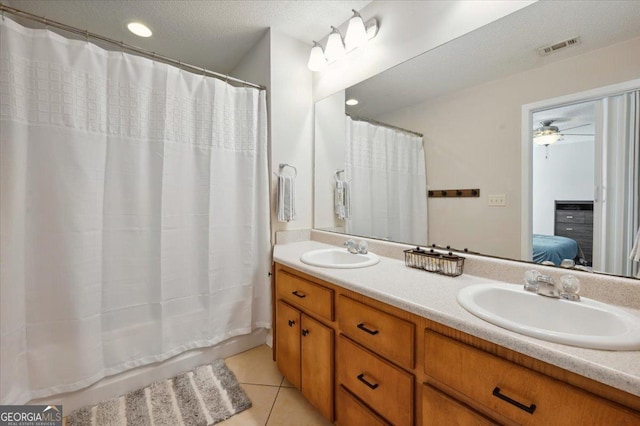 ensuite bathroom featuring ensuite bath, visible vents, a sink, and tile patterned floors