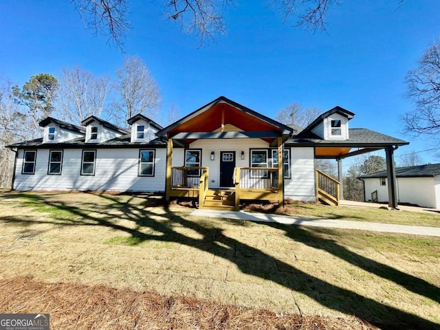 back of house featuring a carport, covered porch, and a yard