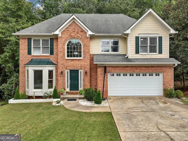 view of front of home featuring a shingled roof, a front yard, concrete driveway, and brick siding