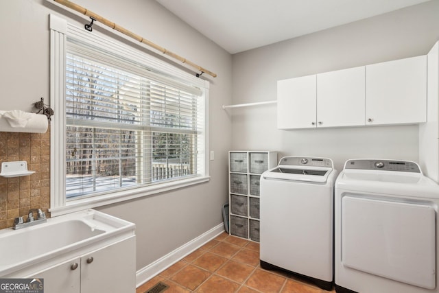 clothes washing area featuring cabinet space, visible vents, baseboards, tile patterned floors, and washing machine and dryer