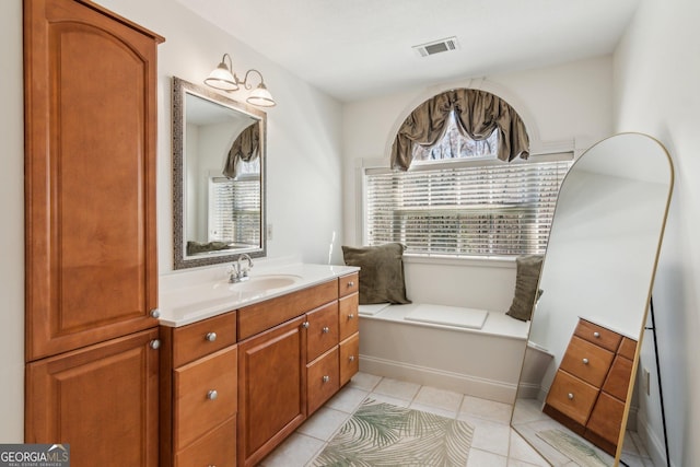 bathroom featuring vanity, visible vents, and tile patterned floors