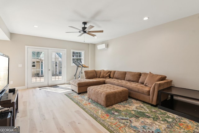 living room featuring ceiling fan, recessed lighting, wood finished floors, an AC wall unit, and french doors