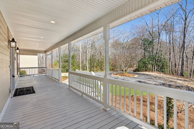 wooden terrace featuring covered porch