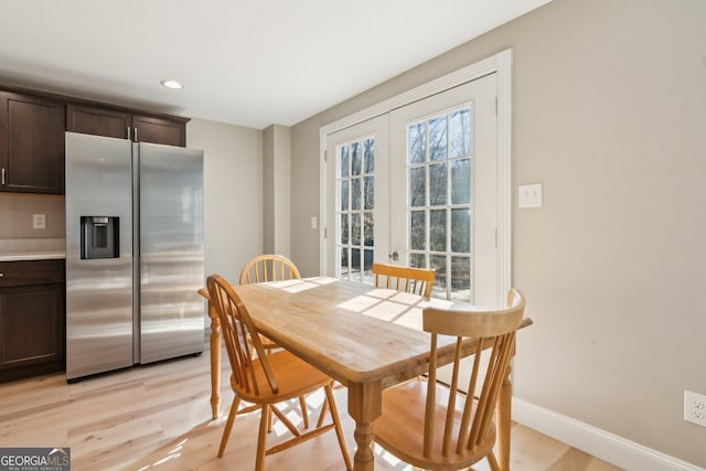 dining room featuring french doors, light wood-type flooring, recessed lighting, and baseboards