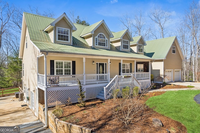 cape cod-style house with a garage, driveway, central AC unit, metal roof, and a porch