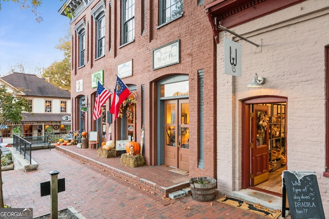 doorway to property featuring brick siding