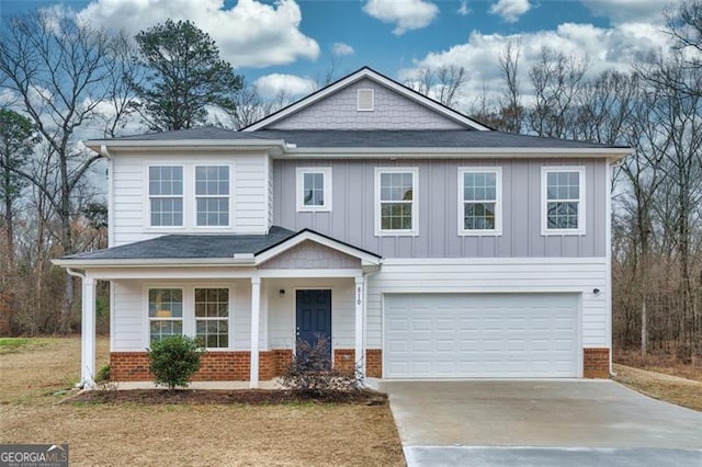 view of front of property featuring a garage, brick siding, driveway, and board and batten siding