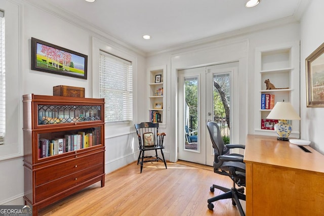 office featuring built in shelves, light wood-style floors, and ornamental molding