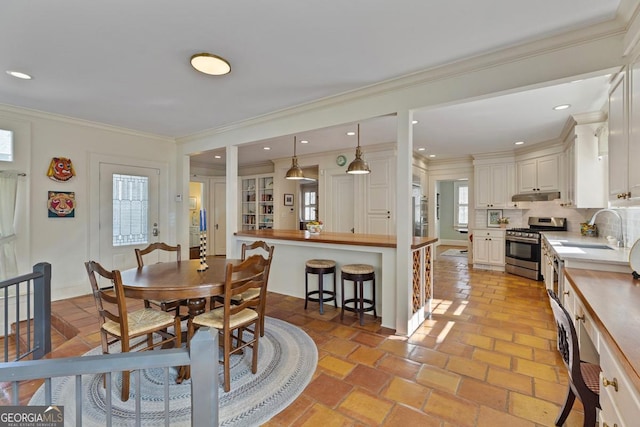 dining room with recessed lighting and crown molding