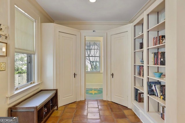 doorway to outside featuring crown molding and a wealth of natural light