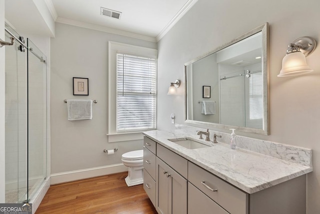 full bathroom with visible vents, ornamental molding, vanity, wood finished floors, and baseboards