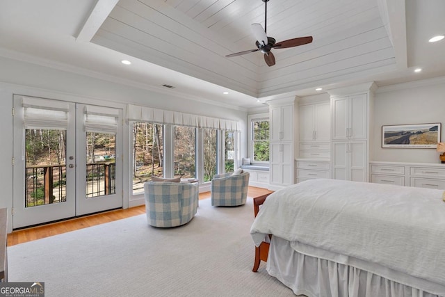 bedroom with ornamental molding, a raised ceiling, and access to exterior