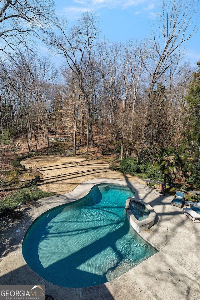 view of swimming pool featuring a pool with connected hot tub