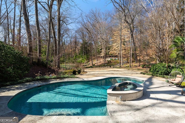 view of pool featuring a pool with connected hot tub