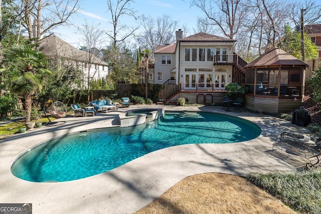 view of pool featuring a patio, stairway, fence, a gazebo, and a pool with connected hot tub