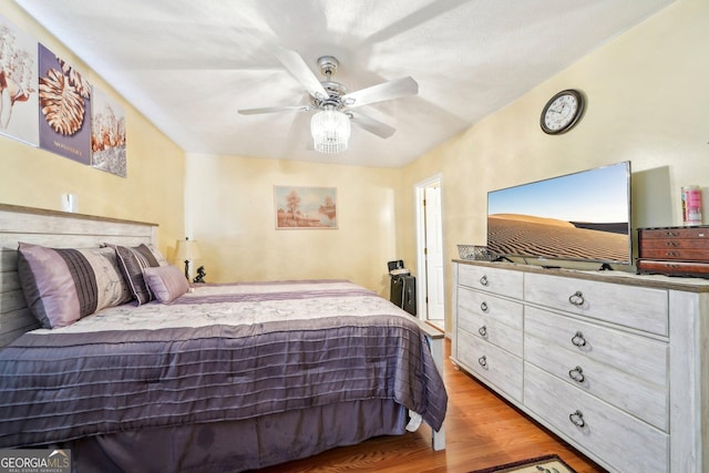 bedroom with light wood-style floors and a ceiling fan